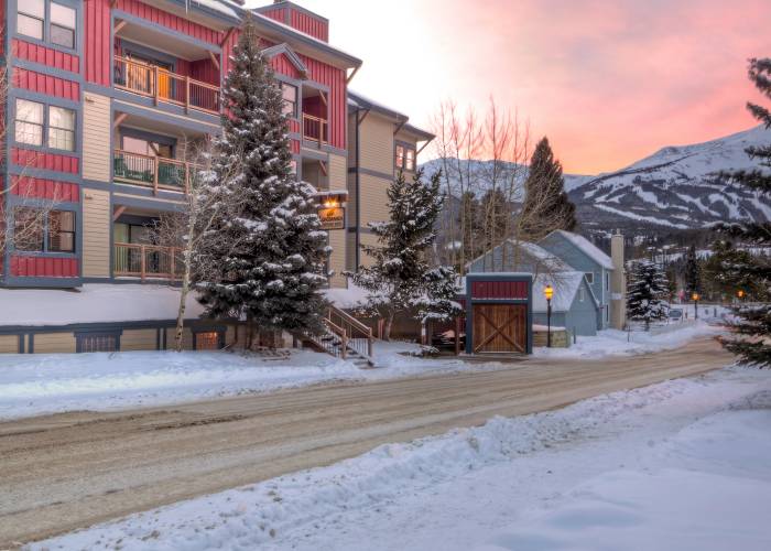 Longbranch condominium building in winter with mountain views